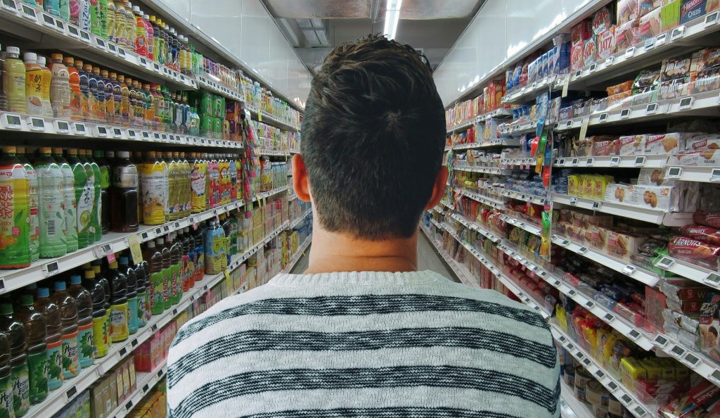 Man looking down grocery store ailse