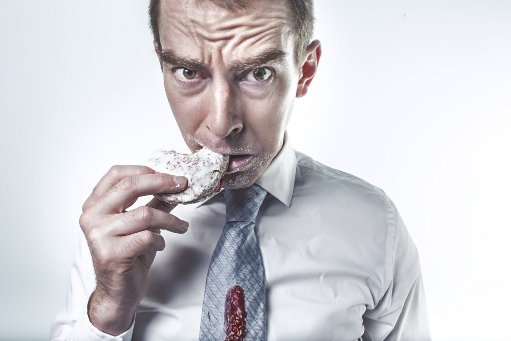 Man eating pastry 